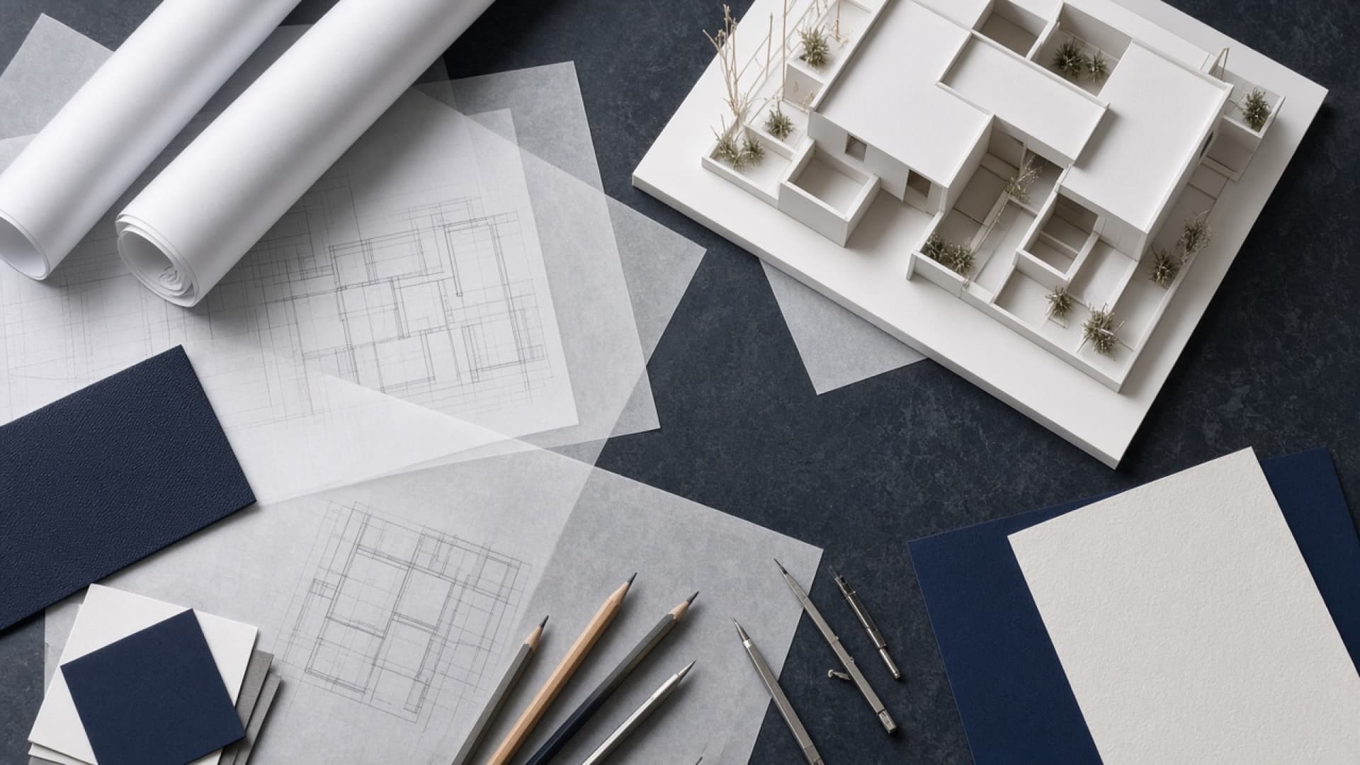 Architectural workshop table with drawings and a scale model